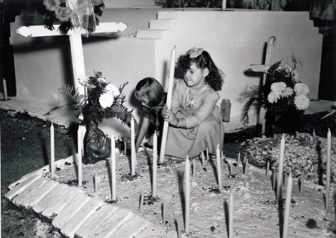 bserving All Saints' Day in Bayou Barataria, just below New Orleans, children place candles on a family grave. The plot on the right, marked by oyster shells, is said to be the resting place of Pirate Jean Lafitte. November 1, 1946. (ACME Telefoto/The Times-Picayune archive)